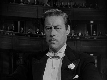 Movie still from “Unfaithfully Yours” (1948), directed by Preston Sturges – A black and white photo of a man in a tuxedo; Close Up shot, Low angle