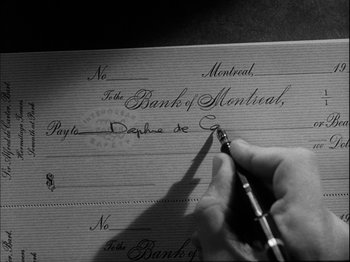 Movie still from “Unfaithfully Yours” (1948), directed by Preston Sturges – A person writing on a bank of montreal cheque; Extreme Close Up shot, High angle