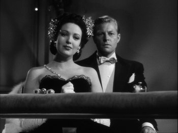 Movie still from “Unfaithfully Yours” (1948), directed by Preston Sturges – A man and a woman sitting next to each other; Medium shot, Low angle