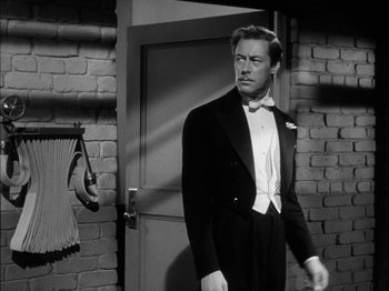 Movie still from “Unfaithfully Yours” (1948), directed by Preston Sturges – A black and white photo of a man in a tuxedo; Medium shot, Over the shoulder angle