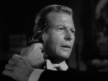 Movie still from “Unfaithfully Yours” (1948), directed by Preston Sturges – A black and white photo of a man getting his hair cut; Close Up shot, Low angle