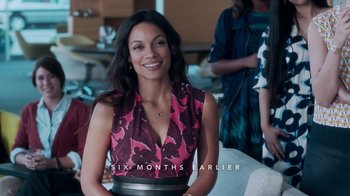 Movie still from “Unforgettable” (2017), directed by Denise Di Novi – A woman in a pink and black dress smiling for the camera; Medium shot, Over the shoulder angle