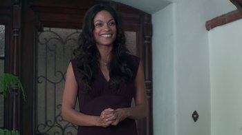 Movie still from “Unforgettable” (2017), directed by Denise Di Novi – A woman in a purple dress smiling for the camera; Medium shot, High angle