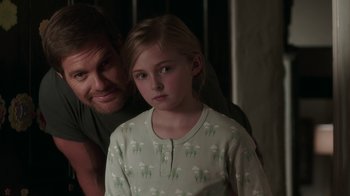 Movie still from “Unforgettable” (2017), directed by Denise Di Novi – A man and a little girl are posing for a picture; Close Up shot, Over the shoulder angle