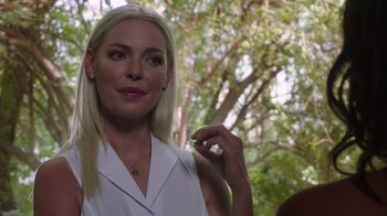 Movie still from “Unforgettable” (2017), directed by Denise Di Novi – A beautiful blond haired woman posing for a picture; Close Up shot, Over the shoulder angle