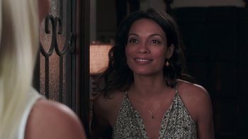 Movie still from “Unforgettable” (2017), directed by Denise Di Novi – A woman smiling for the camera in front of a door; Close Up shot, Over the shoulder angle