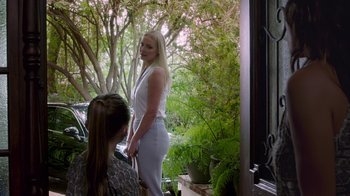 Movie still from “Unforgettable” (2017), directed by Denise Di Novi – A woman standing next to another woman in a white dress; Medium shot, Over the shoulder angle