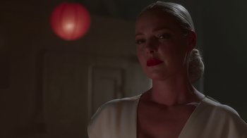 Movie still from “Unforgettable” (2017), directed by Denise Di Novi – A woman in a white shirt and red lipstick looking to her left; Close Up shot, Low angle