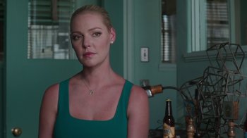 Movie still from “Unforgettable” (2017), directed by Denise Di Novi – A beautiful woman in a green top standing in a room; Close Up shot, Over the shoulder angle