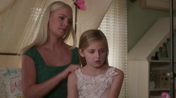 Movie still from “Unforgettable” (2017), directed by Denise Di Novi – A young girl getting her hair done by a woman; Close Up shot, Over the shoulder angle