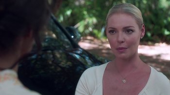 Movie still from “Unforgettable” (2017), directed by Denise Di Novi – A beautiful woman with blonde hair wearing a white shirt; Close Up shot, Over the shoulder angle
