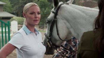 Movie still from “Unforgettable” (2017), directed by Denise Di Novi – A woman standing next to a white horse on a field; Close Up shot, Over the shoulder angle