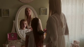 Movie still from “Unforgettable” (2017), directed by Denise Di Novi – A woman and two young girls in front of a bathroom mirror; Medium shot, Over the shoulder angle