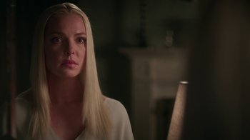 Movie still from “Unforgettable” (2017), directed by Denise Di Novi – A woman with long blonde hair looking at the camera; Close Up shot, Over the shoulder angle