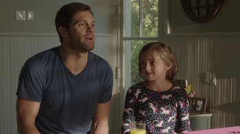 Movie still from “Unforgettable” (2017), directed by Denise Di Novi – A man and a little girl sitting next to each other; Medium shot, Over the shoulder angle