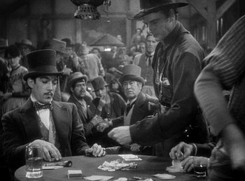 Movie still from “Union Pacific” (1939), directed by Cecil B. DeMille – A group of men playing a game of poker; Medium shot, Over the shoulder angle