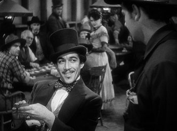 Movie still from “Union Pacific” (1939), directed by Cecil B. DeMille – A black and white photo of a man wearing a top hat; Medium shot, Over the shoulder angle