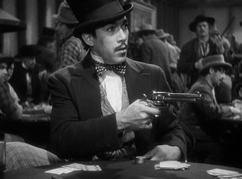 Movie still from “Union Pacific” (1939), directed by Cecil B. DeMille – A black and white photo of a man holding a gun; Close Up shot, Over the shoulder angle