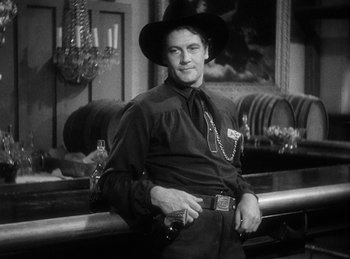 Movie still from “Union Pacific” (1939), directed by Cecil B. DeMille – A man wearing a cowboy hat and holding a gun; Medium shot, Low angle