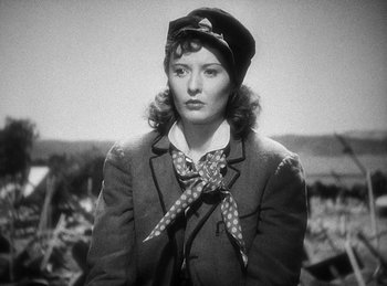 Movie still from “Union Pacific” (1939), directed by Cecil B. DeMille – A black and white photo of a woman wearing a hat and a bow tie; Close Up shot, Low angle