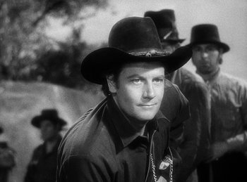 Movie still from “Union Pacific” (1939), directed by Cecil B. DeMille – A black and white photo of a man wearing a cowboy hat; Close Up shot, Low angle