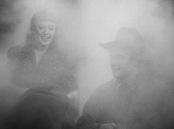 Movie still from “Union Pacific” (1939), directed by Cecil B. DeMille – A man and a woman are sitting in the fog; Medium shot, Over the shoulder angle