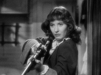 Movie still from “Union Pacific” (1939), directed by Cecil B. DeMille – A black - and - white photo of a woman holding a rifle; Close Up shot, Over the shoulder angle