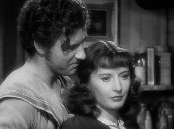 Movie still from “Union Pacific” (1939), directed by Cecil B. DeMille – A man and a woman standing next to each other; Close Up shot, Over the shoulder angle