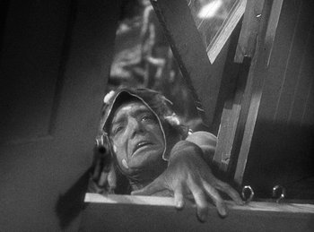 Movie still from “Union Pacific” (1939), directed by Cecil B. DeMille – An old photo of a man leaning up against a wall; Close Up shot, Low angle