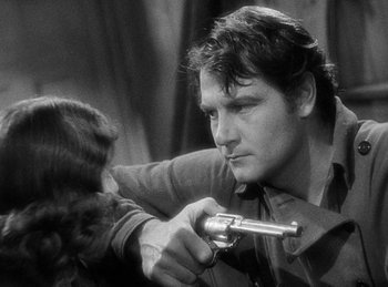Movie still from “Union Pacific” (1939), directed by Cecil B. DeMille – A man and a woman are holding a gun; Close Up shot, Over the shoulder angle