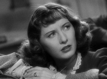 Movie still from “Union Pacific” (1939), directed by Cecil B. DeMille – An old photo of a woman looking at the camera; Close Up shot, Over the shoulder angle