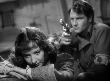 Movie still from “Union Pacific” (1939), directed by Cecil B. DeMille – A man and a woman holding guns in a black and white photo; Close Up shot, Over the shoulder angle