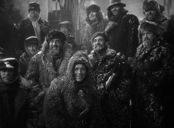 Movie still from “Union Pacific” (1939), directed by Cecil B. DeMille – A black and white photo of a group of people; Wide shot, High angle