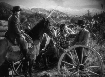 Movie still from “Union Pacific” (1939), directed by Cecil B. DeMille – A group of men sitting on top of horses; Wide shot, High angle