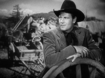 Movie still from “Union Pacific” (1939), directed by Cecil B. DeMille – A black and white photo of a man wearing a cowboy hat; Medium shot, Low angle