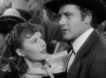 Movie still from “Union Pacific” (1939), directed by Cecil B. DeMille – A man and a woman standing next to each other; Close Up shot, Low angle