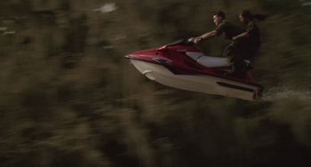 Movie still from “Universal Soldier: The Return” (1999), directed by Mic Rodgers – A man on a jet ski in the middle of the night; Extreme Wide shot, Overhead angle