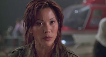 Movie still from “Universal Soldier: The Return” (1999), directed by Mic Rodgers – A person with long brown hair; Close Up shot, Low angle