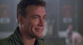 Movie still from “Universal Soldier: The Return” (1999), directed by Mic Rodgers – A person wearing a green shirt; Close Up shot, Low angle