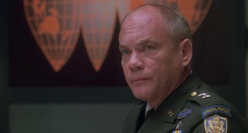 Movie still from “Universal Soldier: The Return” (1999), directed by Mic Rodgers – A man in a military uniform is looking at the camera; Close Up shot, Low angle