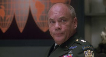 Movie still from “Universal Soldier: The Return” (1999), directed by Mic Rodgers – A man in a military uniform is looking at the camera; Close Up shot, Low angle