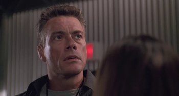 Movie still from “Universal Soldier: The Return” (1999), directed by Mic Rodgers – A person looking at a person; Close Up shot, Low angle