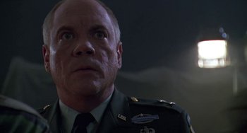 Movie still from “Universal Soldier: The Return” (1999), directed by Mic Rodgers – A person wearing a military uniform; Close Up shot, Low angle
