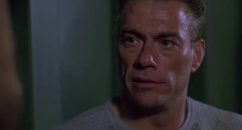Movie still from “Universal Soldier: The Return” (1999), directed by Mic Rodgers – A person looking at the camera; Close Up shot, Low angle