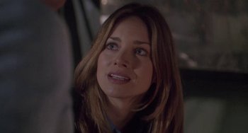 Movie still from “Universal Soldier: The Return” (1999), directed by Mic Rodgers – A person with long brown hair; Close Up shot, Over the shoulder angle