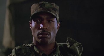 Movie still from “Universal Soldier: The Return” (1999), directed by Mic Rodgers – A man in a military uniform wearing a hat; Close Up shot, Low angle