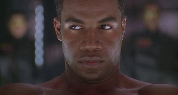 Movie still from “Universal Soldier: The Return” (1999), directed by Mic Rodgers – A man's face in a dark room; Close Up shot, Low angle