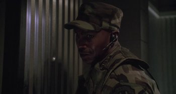Movie still from “Universal Soldier: The Return” (1999), directed by Mic Rodgers – A man in a military uniform wearing a headset; Close Up shot, Low angle