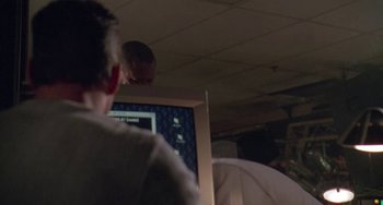 Movie still from “Universal Soldier: The Return” (1999), directed by Mic Rodgers – A man sitting in front of a computer monitor; Close Up shot, Over the shoulder angle