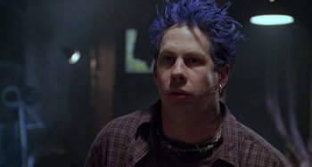 Movie still from “Universal Soldier: The Return” (1999), directed by Mic Rodgers – A man with blue hair is looking at the camera; Close Up shot, Low angle